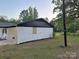 View of the home's white brick siding and neatly trimmed landscaping, highlighting the property's curb appeal at 201 Harley St, Wadesboro, NC 28170