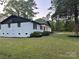 View of the house with well-kept lawn, classic shutters, and manicured landscaping at 201 Harley St, Wadesboro, NC 28170