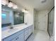 Modern bathroom with double vanity, marble countertops, glass-enclosed shower, and contemporary lighting at 2019 Puddle Pond Rd, Indian Trail, NC 28079