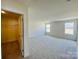 Large bedroom with carpet, walk-in closet, neutral walls, and natural light from two windows at 2019 Puddle Pond Rd, Indian Trail, NC 28079