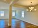 Spacious dining room with hardwood floors, white walls, and a contemporary chandelier at 2019 Puddle Pond Rd, Indian Trail, NC 28079