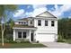 Beautiful two-story home with white siding, a two-car garage, and a well-manicured lawn at 2019 Puddle Pond Rd, Indian Trail, NC 28079