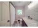 Bathroom showcasing new vanity, modern fixtures, and shiplap accent wall with natural light at 20337 Nc Hwy 73 Hwy, Albemarle, NC 28001