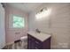 Updated bathroom featuring a marble countertop vanity and decorative lighting at 20337 Nc Hwy 73 Hwy, Albemarle, NC 28001