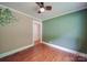 A neutral bedroom featuring hardwood floors and calming neutral green walls at 20337 Nc Hwy 73 Hwy, Albemarle, NC 28001