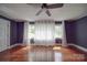 An airy bedroom is brightened by natural light and white curtains, showcasing its hardwood floors at 20337 Nc Hwy 73 Hwy, Albemarle, NC 28001