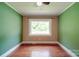 A bright and spacious bedroom featuring hardwood floors and a large window at 20337 Nc Hwy 73 Hwy, Albemarle, NC 28001