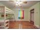 Cozy bedroom featuring a modern bunk bed with desk, colorful curtains, and hardwood floors at 20337 Nc Hwy 73 Hwy, Albemarle, NC 28001