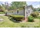 Side view of the home with well maintained landscaping, healthy plants, and neutral siding at 20337 Nc Hwy 73 Hwy, Albemarle, NC 28001
