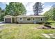 Exterior view of home with a lush green lawn, bright siding, and a detached garage to the left at 20337 Nc Hwy 73 Hwy, Albemarle, NC 28001