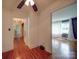 View from the hallway into the naturally lit living room showcasing the wood floors at 20337 Nc Hwy 73 Hwy, Albemarle, NC 28001