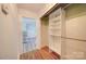View down the hallway to kitchen showcasing the wood floors and closet with organizing system at 20337 Nc Hwy 73 Hwy, Albemarle, NC 28001