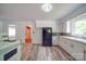 Kitchen featuring white cabinetry, black refrigerator, and wood-look flooring at 20337 Nc Hwy 73 Hwy, Albemarle, NC 28001