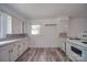 Kitchen featuring white cabinets and countertops with wood-look flooring at 20337 Nc Hwy 73 Hwy, Albemarle, NC 28001
