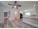 Open living room featuring a ceiling fan, white walls, and wood-look flooring at 20337 Nc Hwy 73 Hwy, Albemarle, NC 28001