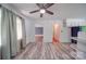 Bright living room with ceiling fan, white walls, and vinyl wood-look floors at 20337 Nc Hwy 73 Hwy, Albemarle, NC 28001