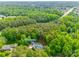 Aerial view of the home featuring a swimming pool, large backyard, and is surrounded by mature trees at 2062 High Pines Rd, Rock Hill, SC 29732