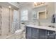 Modern bathroom with a double vanity, and a shower with blue and white tiles at 2062 High Pines Rd, Rock Hill, SC 29732