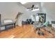 Spacious bonus room featuring hardwood floors, workout equipment, and a dedicated workspace with a computer at 2062 High Pines Rd, Rock Hill, SC 29732