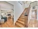 Inviting entryway featuring hardwood floors, staircase, and view into the living room at 2062 High Pines Rd, Rock Hill, SC 29732