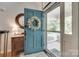 Charming foyer with a decorative wreath on a blue door, a stylish mirror and wood floors at 2062 High Pines Rd, Rock Hill, SC 29732