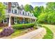 Well-maintained brick home with inviting front porch, lush landscaping, and a sidewalk entrance at 2062 High Pines Rd, Rock Hill, SC 29732