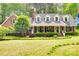 Charming brick home with a manicured front lawn, mature landscaping, and a cozy front porch at 2062 High Pines Rd, Rock Hill, SC 29732