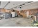 Spacious garage featuring ample storage cabinets, a utility sink, and a refrigerator for convenience at 2062 High Pines Rd, Rock Hill, SC 29732