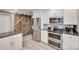 Bright kitchen showcasing stainless steel appliances, a stylish barn door, and ample counter space at 2062 High Pines Rd, Rock Hill, SC 29732