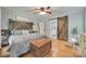 Main bedroom showcasing rustic wood accents, natural light, and a barn door to the bath at 2062 High Pines Rd, Rock Hill, SC 29732