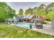 Aerial view of a stunning backyard with a sparkling pool, lounge areas, and a well-maintained lawn at 2062 High Pines Rd, Rock Hill, SC 29732