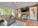 Inviting sunroom with brick accent wall, cozy seating, TV, and storage, creating a cozy entertaining space at 2062 High Pines Rd, Rock Hill, SC 29732