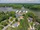 Beautiful aerial shot of a lakeside home with lush landscaping and convenient access to a private marina at 216 Commodore Ct, Belmont, NC 28012