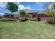 A sprawling lawn, brick exterior, and well-maintained garden beds enhance the charm of this property at 216 Commodore Ct, Belmont, NC 28012