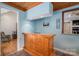Finished basement area features a small kitchenette, blue walls, and wood-paneled ceiling at 216 Commodore Ct, Belmont, NC 28012