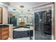 Bathroom features a jetted tub, glass shower, black countertops, and large mirror at 216 Commodore Ct, Belmont, NC 28012
