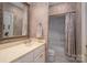 Bathroom with vanity and framed mirror next to bathtub-shower combo at 216 Commodore Ct, Belmont, NC 28012