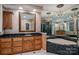 Bathroom boasts a vanity with black countertop, large framed mirror, and a jetted tub at 216 Commodore Ct, Belmont, NC 28012