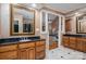 Bathroom shows a double vanity with black countertops, ceramic tile flooring, and a view of the main bedroom at 216 Commodore Ct, Belmont, NC 28012