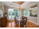 Dining room features hardwood floors, a stylish chandelier, and plantation shutters at 216 Commodore Ct, Belmont, NC 28012