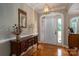 Inviting entryway with hardwood floors, decorative mirror, and a stylish light fixture at 216 Commodore Ct, Belmont, NC 28012