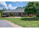 Charming brick home with a well-maintained lawn and mature landscaping at 216 Commodore Ct, Belmont, NC 28012