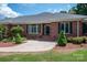 A brick facade, well-manicured landscaping, and a welcoming entrance define the curb appeal of this home at 216 Commodore Ct, Belmont, NC 28012