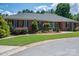 Charming brick home with a well-maintained lawn and mature landscaping at 216 Commodore Ct, Belmont, NC 28012