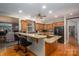 Spacious kitchen with a large granite island, custom cabinets, and stainless steel appliances at 216 Commodore Ct, Belmont, NC 28012