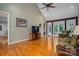 Bright living room with hardwood floors, a ceiling fan, and double glass doors at 216 Commodore Ct, Belmont, NC 28012