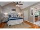 Well-decorated main bedroom features a tray ceiling, ceiling fan, and adjoining en suite at 216 Commodore Ct, Belmont, NC 28012