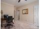 Office featuring a ceiling fan, large desk, and a view into the en suite at 216 Commodore Ct, Belmont, NC 28012