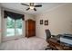Well-lit office features a large window, ceiling fan, and a hardwood cabinet at 216 Commodore Ct, Belmont, NC 28012
