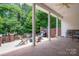 The covered patio with brick and ceiling fan offers an inviting outdoor living and entertaining space at 216 Commodore Ct, Belmont, NC 28012